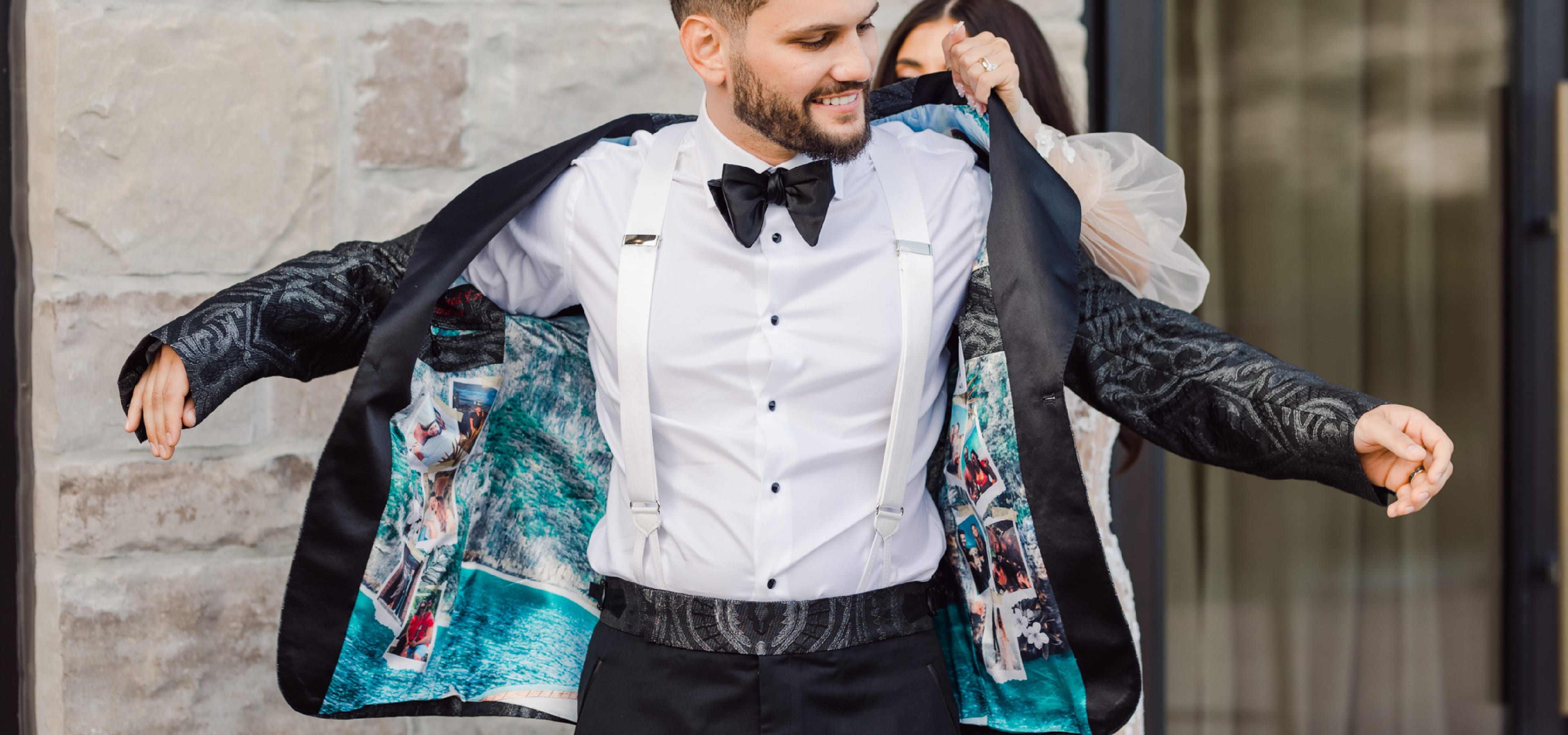 A bride helping a groom put on his custom King & Bay smoking jacket with custom lining
